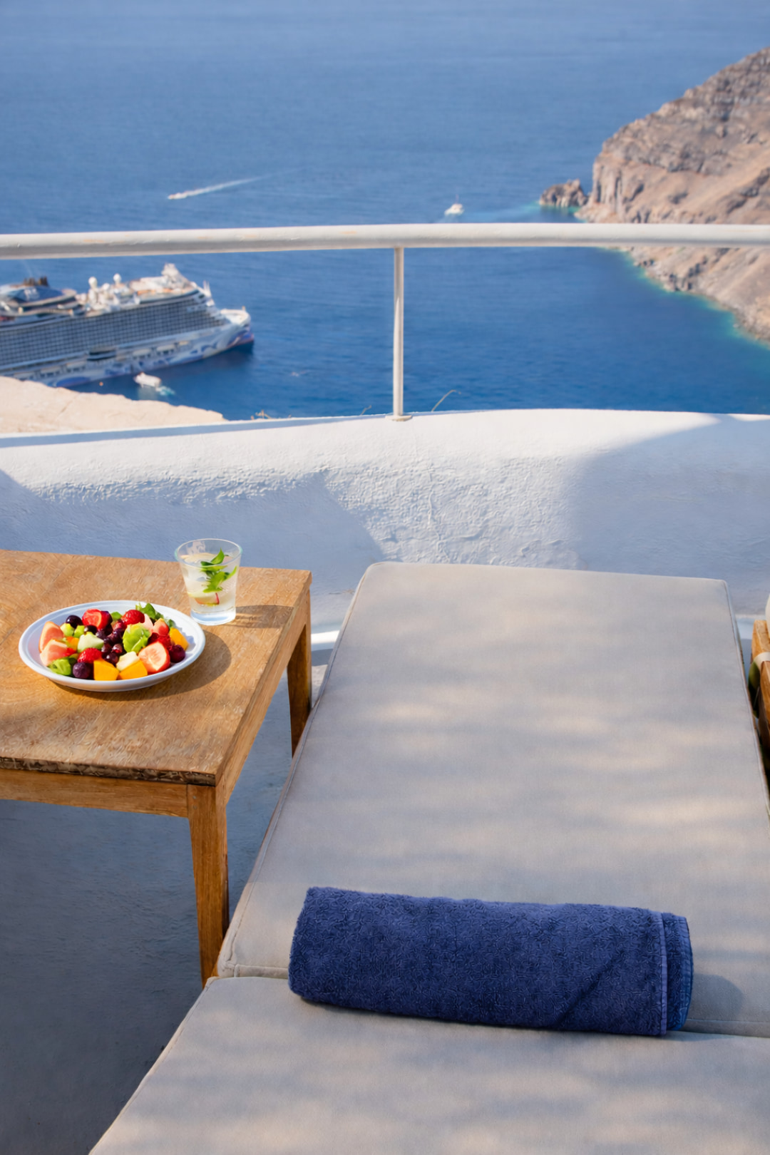 Cruise ship sailing across the Santorini caldera viewed from terrace