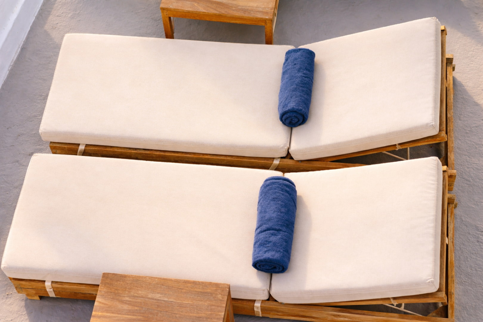 Luxury sunbeds with rolled towels overlooking the Aegean Sea